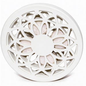 May include: A white, circular decorative object with a geometric, openwork design. The centre features a solid white circle, and the openwork reveals a glimpse of a light-coloured interior. The object is likely made of ceramic or a similar material.