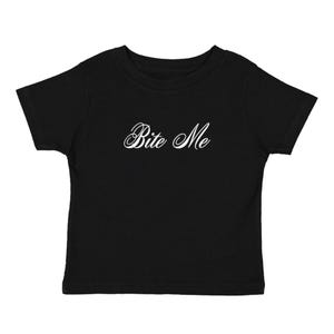 May include: Black toddler t-shirt with the phrase "Bite Me" in elegant white script across the front. The short-sleeved shirt is made of a soft material and is suitable for everyday wear.