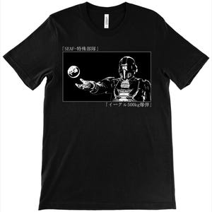 May include: Black t-shirt featuring a white graphic of a futuristic figure holding a sphere, with Japanese text above and below the image. The design is enclosed in a white rectangular frame.