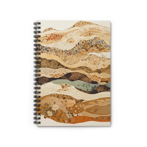 May include: Spiral-bound notebook featuring an abstract design of layered, textured shapes in shades of brown, beige, and tan. The cover art resembles a landscape with organic forms and patterns, with a white background and black spiral binding.