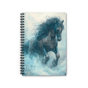 May include: Spiral-bound notebook featuring a digital illustration of a black horse with flowing blue mane and intricate silver filigree. The horse is depicted in a dynamic pose, emerging from a misty, ethereal background. The notebook's design is suitable for note-taking or journaling.