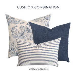 Könnte beinhalten: Ein Set aus drei Kissen mit der Aufschrift CUSHION COMBINATION und WESTWAY INTERIORS. Ein quadratisches Kissen zeigt ein blau-weißes Toile-Muster, ein quadratisches Kissen ist einfarbig dunkelblau und ein rechteckiges Kissen hat blau-weiße Streifen.