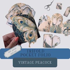May include: A collection of paper ephemera featuring peacock and butterfly wing motifs in shades of blue, green, and cream. The set includes tags, cards, and a trifold pocket folio with the text DIY: print and cut, TRIFOLD POCKET FOLIO, VINTAGE PEACOCK.