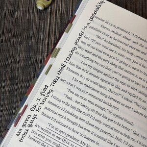 Puede incluir: Libro abierto con texto y marcadores de p&aacute;gina coloridos. El texto manuscrito en la p&aacute;gina dice: "Not gonna lie, I find those guys so boring. They think having power is a personality."
