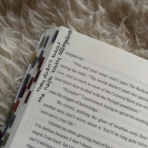 Puede incluir: Libro abierto con texto y marcadores de p&aacute;gina coloridos. El texto incluye las frases "They didn't beat the repo baby allegations." El libro est&aacute; abierto en una p&aacute;gina con texto impreso.