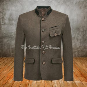 May include: A brown wool jacket with a mandarin collar, dark green trim, and decorative buttons. The jacket has two front pockets and a small chest pocket. The text "The Scottish Kilt House" is printed on the jacket.