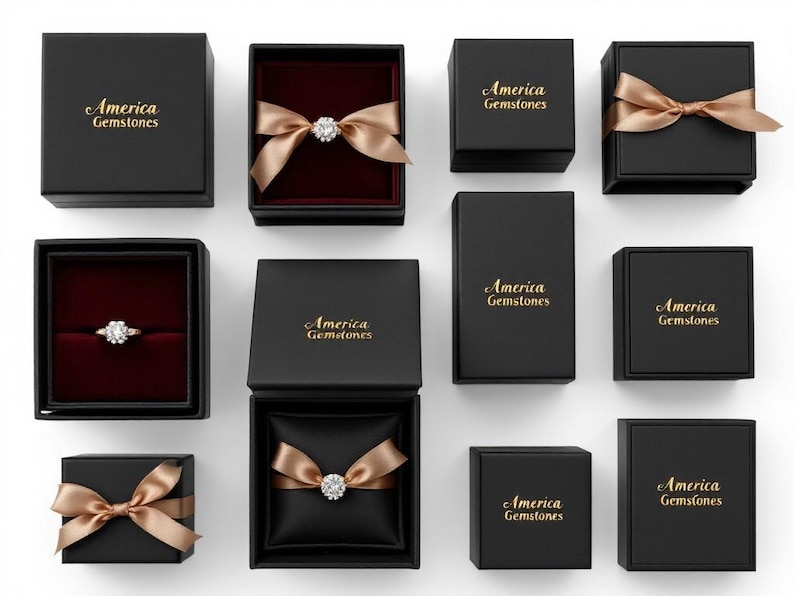 May include: An overhead shot of several black jewelry boxes, some open to reveal rings and gemstones. The boxes are adorned with gold bows and the words "America Gemstones" in gold lettering. The interiors of the boxes are lined with red or black fabric.