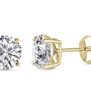 May include: A pair of gold stud earrings with round clear cubic zirconia stones.