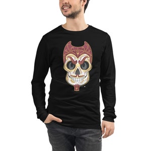 May include: Black long-sleeve t-shirt with a white and gold sugar skull design. The skull has red horns and intricate details.