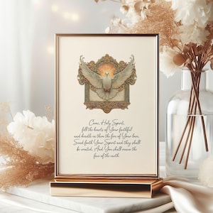 May include: A framed print with a gold-coloured frame, displaying a dove with open wings within a decorative border. The print includes the text "Come, Holy Spirit..." in a flowing script. The image has a peaceful, spiritual theme.