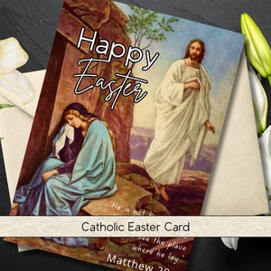 May include: A Catholic Easter card with the words "Happy Easter" in script. The card features an illustration of Jesus and a woman. White lilies and a cream-colored envelope are also visible.