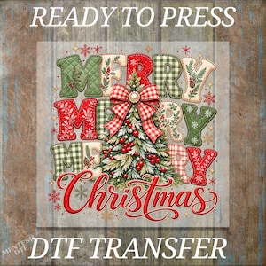 May include: A DTF transfer design featuring the text READY TO PRESS at the top and DTF TRANSFER at the bottom. The central graphic displays the words MERRY CHRISTMAS with a decorated pine tree, red berries, and a red and white gingham bow.