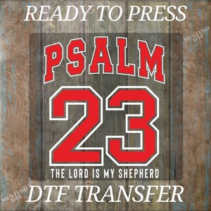 May include: A DTF transfer design featuring the text "READY TO PRESS" at the top. The design includes the word "PSALM" in red with a white outline, and the number "23" in a similar style. Below, it reads "THE LORD IS MY SHEPHERD" and "DTF TRANSFER".