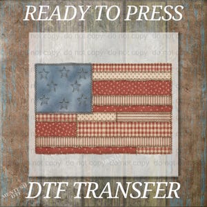 May include: A patriotic DTF transfer featuring a patchwork American flag design. The flag has a blue field with stars and red and white stripes in various patterns. The text "READY TO PRESS" and "DTF TRANSFER" are displayed.