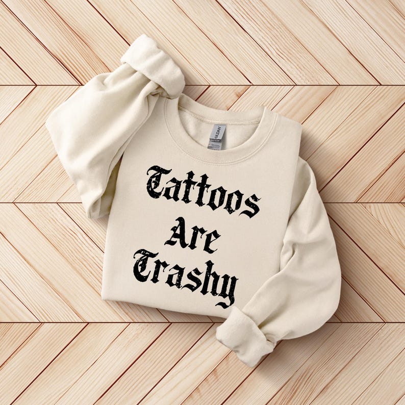 a white sweatshirt with the words tattoos are crashy on it
