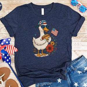 a t - shirt with a picture of a duck holding an american flag