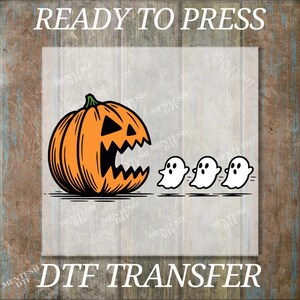 May include: Orange jack-o'-lantern with a carved face and three white ghost figures. The words "READY TO PRESS" and "DTF TRANSFER" are printed above and below the design.