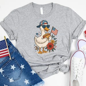 a t - shirt with an american flag and a duck on it