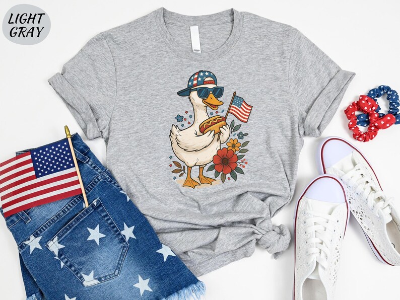 a t - shirt with an american flag and a duck on it