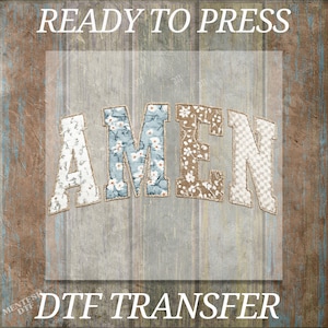 May include: A DTF transfer featuring the word AMEN in a collegiate font. Each letter has a distinct pattern: the A is white with small floral motifs, the M is blue with white flowers, the E is brown with white flowers, and the N is a white checkered pattern.