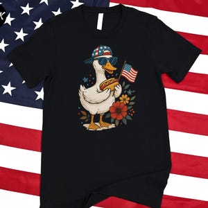 a black t - shirt with a picture of a duck holding an american flag