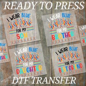 May include: Four ready-to-press iron-on transfers with the text "I wear blue for my" followed by "son", "brother", "daughter", and "best friend". Each design features a colorful puzzle piece handprint.