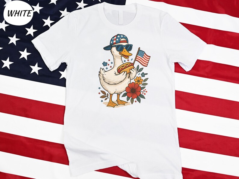 a white shirt with a duck wearing a hat and an american flag