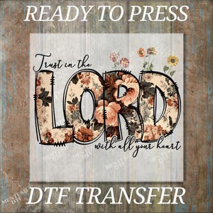 May include: A DTF transfer design with the words "Trust in the Lord with all your heart." The word "LORD" is filled with a floral pattern in shades of peach, brown, and cream. The words "READY TO PRESS" and "DTF TRANSFER" are also visible.