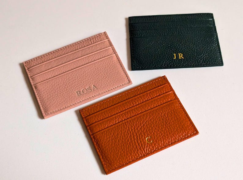 Orange, blush and black cardholder wallets.