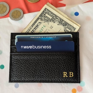 Black card holder with credit cards and money