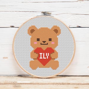 May include: A white ceramic mug with a black handle and the text "But First, Coffee" in a black, handwritten-style font. The mug is on a white surface.