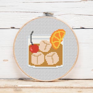 May include: A white ceramic mug with a black handle and the text "But First, Coffee" in a black, handwritten-style font. The mug is on a white surface.