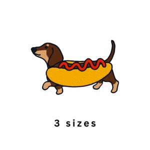 May include: Embroidered patch featuring a dachshund dog inside a hot dog bun with red ketchup. The dog is brown and tan, the bun is yellow, and the text "3 sizes" is below the image.