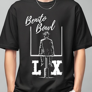 May include: Black t-shirt with a white graphic. The graphic features the text "Benito Bowl" above an illustration of a person sitting on a goalpost. Below the goalpost is the text "LIX".
