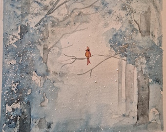May include: Watercolor painting of a winter forest scene. The artwork features a red cardinal perched on a branch, set against a backdrop of snow-covered trees in shades of blue and gray. The painting has a soft, ethereal quality.