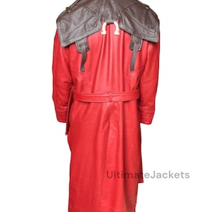 May include: Red leather trench coat with a brown leather shoulder piece. The coat has a belt at the waist and buckle details. The back of the coat features a white Omega symbol. The text "UltimateJackets" is visible.