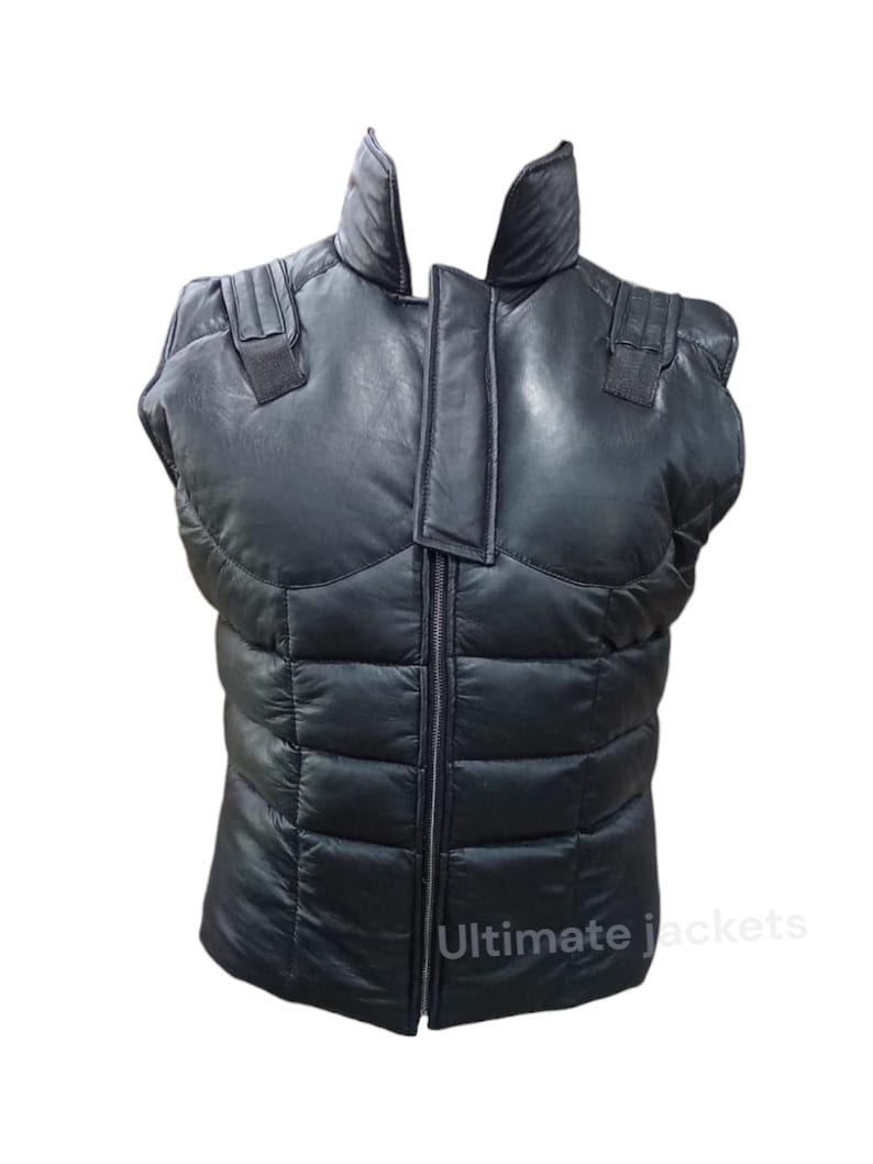 May include: Black quilted vest with a high collar and a full-length zip. The vest has shoulder accents and a padded design. The text "Ultimate jackets" is visible at the bottom. This vest is designed for outerwear.