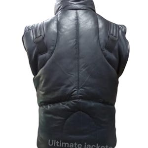 May include: Black leather vest with a high collar and padded design. The vest has shoulder straps and a quilted pattern. The text "Ultimate jackets" is printed at the bottom of the vest.