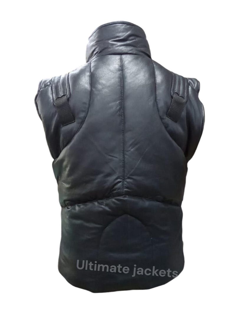 May include: Black leather vest with a high collar and padded design. The vest has shoulder straps and a quilted pattern. The text "Ultimate jackets" is printed at the bottom of the vest.