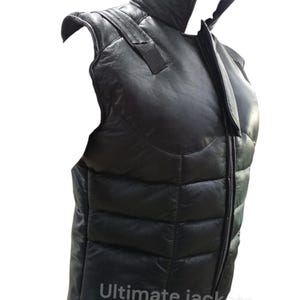 May include: Black leather vest with a high collar and a full-length zip. The vest has a quilted design and shoulder straps. The text "Ultimate jackets" is printed at the bottom of the vest.