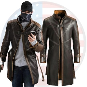 May include: A brown leather coat with a contrasting brown collar and trim. The coat has a long, tailored design with a belt and buckle details. The image also shows a person wearing the coat, a black cap, and a black face covering.
