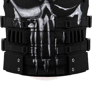 May include: Black tactical vest with multiple pouches and adjustable straps. The vest features a white skull design on the chest area. The vest has multiple rows of loops and pouches for carrying equipment. The vest is made of durable, heavy-duty material.