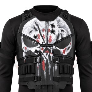 May include: Black tactical vest featuring a white skull design with red splatter details. The vest has multiple pouches and adjustable straps. The skull design is centered on the chest, with a distressed, battle-worn appearance.