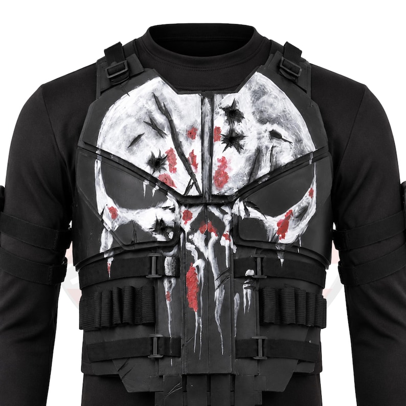 May include: Black tactical vest featuring a white skull design with red splatter details. The vest has multiple pouches and adjustable straps. The skull design is centered on the chest, with a distressed, battle-worn appearance.