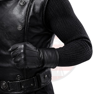 May include: A black leather waistcoat featuring a double-breasted button closure, paired with a black ribbed knit long-sleeve shirt. A black leather glove is worn on the hand, and a black leather belt with a small attached pouch is fastened at the waist.