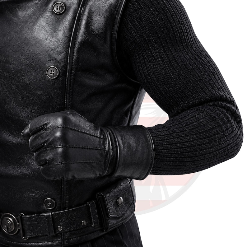 May include: A black leather waistcoat featuring a double-breasted button closure, paired with a black ribbed knit long-sleeve shirt. A black leather glove is worn on the hand, and a black leather belt with a small attached pouch is fastened at the waist.