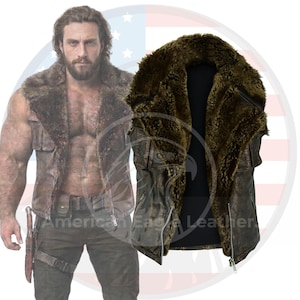 May include: Brown leather vest with a fur collar. The vest has a zipper closure and two front pockets. The fur collar is a dark brown color. The vest is displayed on a white background.