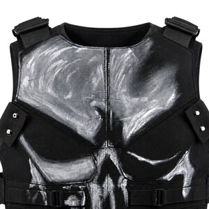 May include: Black tactical vest featuring a white skull design on the chest. The vest has adjustable straps, buckles, and a high neckline. The skull design is painted in a distressed style, adding to the vest's rugged appearance.