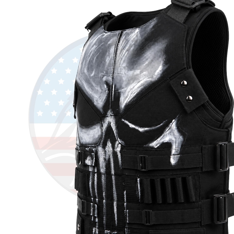 May include: Black tactical vest with a white skull design on the front. The vest features adjustable straps, multiple pouches, and a padded interior. The design is a stylized skull, with a glossy finish. The vest is made of durable, heavy-duty material.