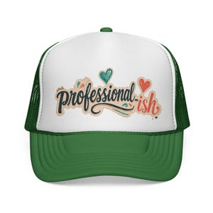 May include: A green and white trucker hat featuring a white front panel with the text "professional-ish" in a dark blue and red script font, accented by small teal and red heart illustrations above the lettering and a solid green brim.